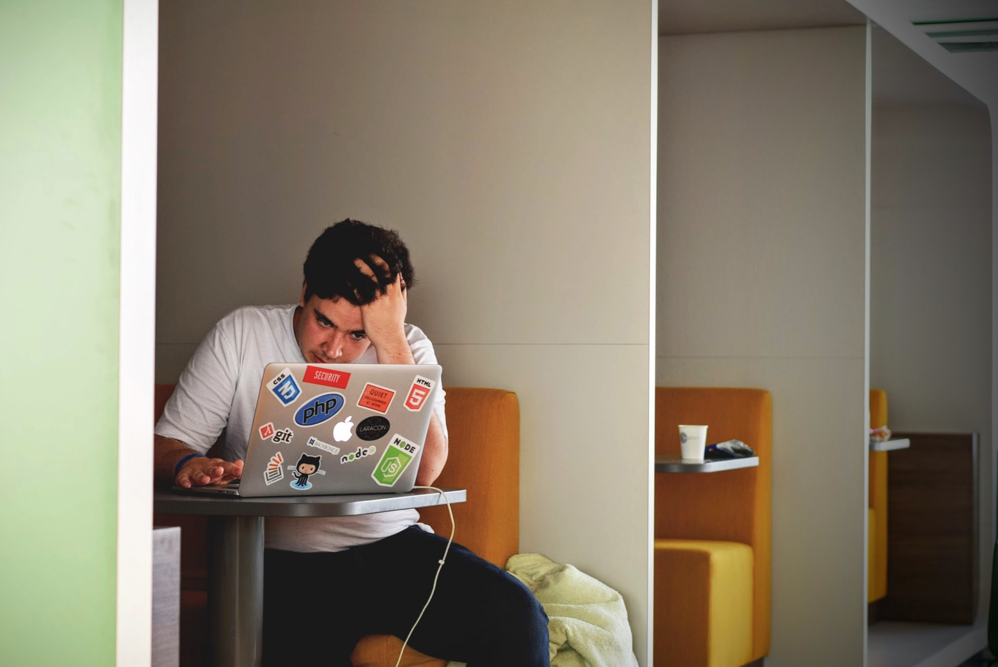 A Stressed man looking at a computer